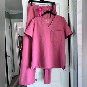 FIGS pink scrub pants and top with neon pink tie.